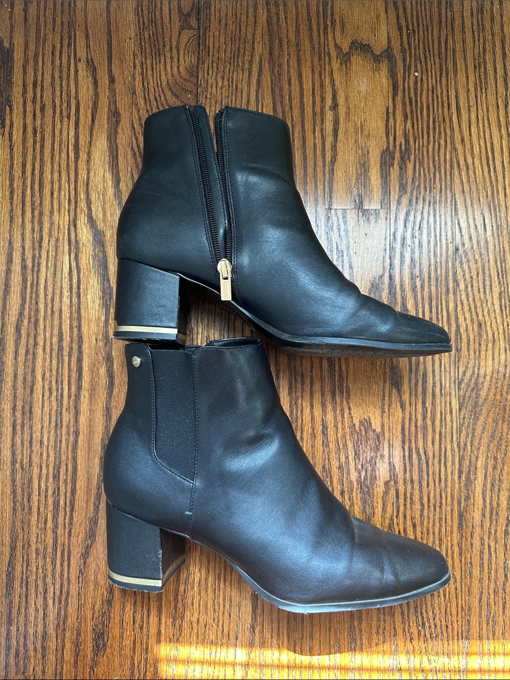 Calvin Klein black leather Chelsea zip up heeled booties with gold detail